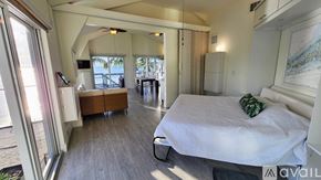 Big Pine Key house for rent - A bedroom with a large bed and a balcony overlooking the water.