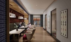 Nashville apartment for rent - Modern business lounge with booth seating, wood accents, and natural light.
