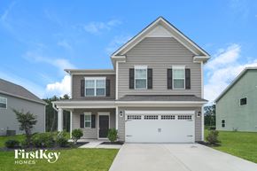 Kannapolis house for rent - A two-story house with a garage is showcased in the image.