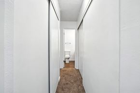 Vallejo apartment for rent - A narrow hallway with a carpeted floor and white walls.