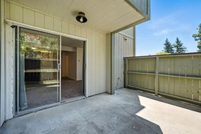 Vallejo apartment for rent - A patio area of a house with a sliding glass door and a wooden fence.
