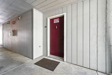 Vallejo apartment for rent - A red door is in a white building.