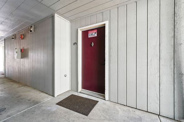 Vallejo apartment for rent - A red door is in a white building.