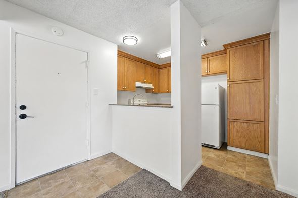 Vallejo apartment for rent - A kitchen with wooden cabinets and a white refrigerator.