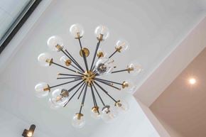 Victoria apartment for rent - A chandelier with multiple bulbs is hanging from the ceiling.