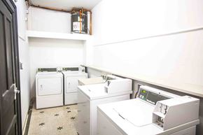 Victoria apartment for rent - A white washing machine and dryer in a small laundry room.