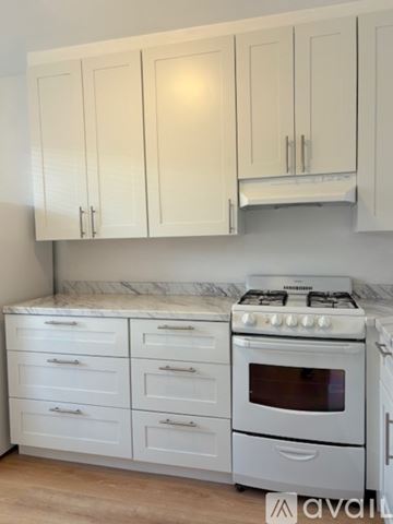 San Rafael apartment for rent - A kitchen with white cabinets and a white gas stove.