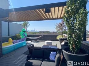 Chicago condo for rent - A sunny patio with a hammock and a pool.