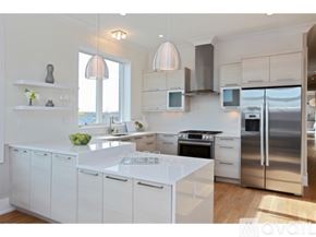 Chicago condo for rent - A modern kitchen with white cabinets and stainless steel appliances.
