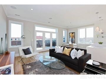Chicago condo for rent - A modern living room with a black couch and a glass coffee table.