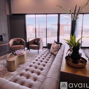 Salt Lake City apartment for rent - A living room with a large window and a view of a construction site.