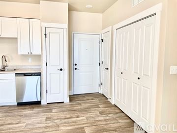 Missoula apartment for rent - A kitchen with white cabinets and a white dishwasher.