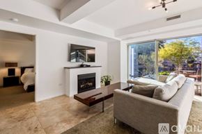 Scottsdale condo for rent - A modern living room with a fireplace and a couch.