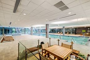 Scottsdale condo for rent - A large indoor swimming pool with a table and chairs.