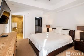 Scottsdale condo for rent - A bedroom with a large bed and a wooden dresser.