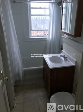 Boston apartment for rent - A bathroom with a toilet, sink, and shower.
