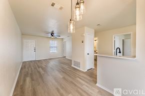 Killeen apartment for rent - A spacious room with wooden flooring and a ceiling fan.