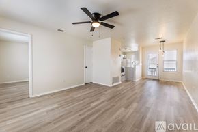 Killeen apartment for rent - A spacious room with a ceiling fan and light fixture.