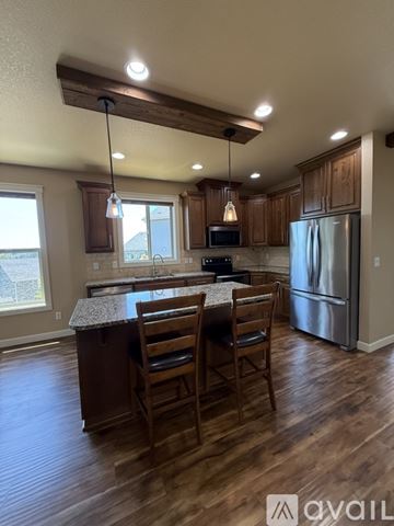 La Center house for rent - A kitchen with wooden cabinets and a granite countertop.