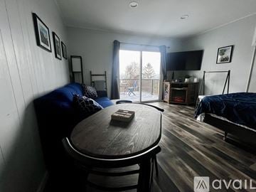 Newburgh apartment for rent - A living room with a blue couch and a wooden table.