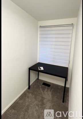 Ellicott City apartment for rent - A bathroom with a toilet, sink, and a shower stool.
