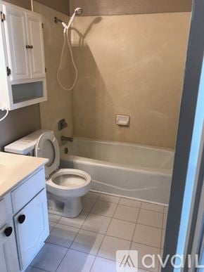 Broussard townhouse for rent - A bathroom with a toilet, sink, and bathtub.