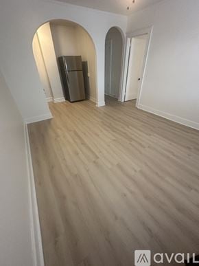 Hammond apartment for rent - A room with wooden flooring and a refrigerator in the corner.