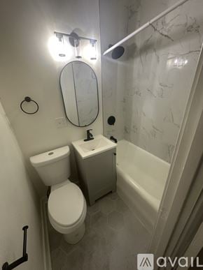 Hammond apartment for rent - A bathroom with a toilet, sink, and mirror.