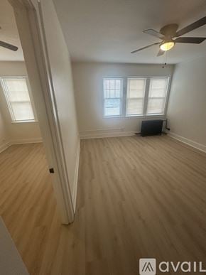 Hammond apartment for rent - A room with a ceiling fan and wooden flooring.
