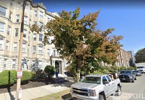 Boston apartment for rent - A white pickup truck is parked on the side of a street.