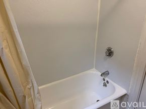 Boston apartment for rent - A white bathtub with a shower head and faucet.