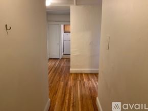 Boston apartment for rent - A hallway with wooden floors and white walls.