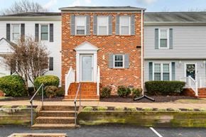 Richmond house for rent - A red brick house with a white door and windows.