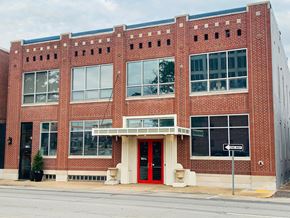 Jonesboro apartment for rent - A red brick building with a black door and windows.
