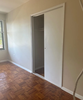 Washington apartment for rent - A room with a wooden floor and a white door.