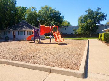 Rancho Cordova apartment for rent - A playground with a red slide and orange climbing frame.