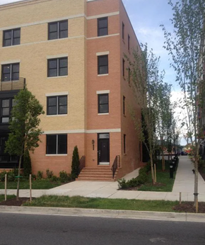 Baltimore house for rent - A building with a red brick facade and a black door.