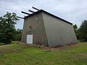 Oklahoma City house for rent - A large grey building with a white door and a metal roof.