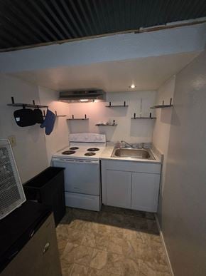 Oklahoma City house for rent - A small kitchen with a sink, stove, and oven.