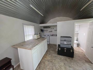 Oklahoma City house for rent - A kitchen with white cabinets and a marble countertop.