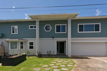 Honolulu apartment for rent - A house with a grey roof and a white garage door.