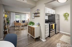 Tampa apartment for rent - A kitchen with white cabinets and stainless steel appliances.