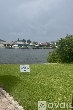 Tampa apartment for rent - A bedroom with a large bed, a radiator, and a painting on the wall.