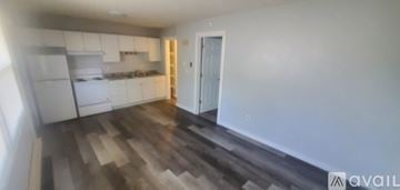 La Crosse apartment for rent - A kitchen with white cabinets and a wooden floor.
