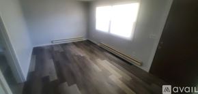 La Crosse apartment for rent - A room with wooden flooring and a window letting in sunlight.