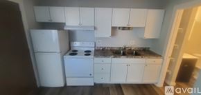 La Crosse apartment for rent - A kitchen with white appliances and cabinets.