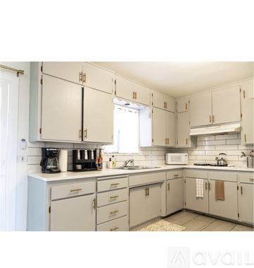 Joshua Tree house for rent - A kitchen with white cabinets and a white counter top.