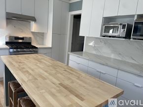 Portland apartment for rent - A kitchen with a wooden countertop and a stove top oven.