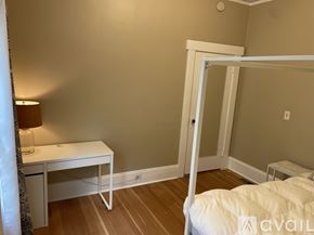 Portland apartment for rent - A bedroom with a white bed and desk.