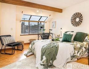 Seattle condo for rent - A bedroom with a large bed and a chair.